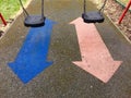 A pair of swings and arrows in a kids playground